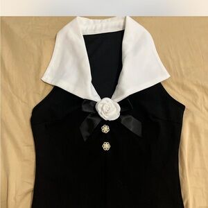 Black and White Sleeveless Top with Floral Accent